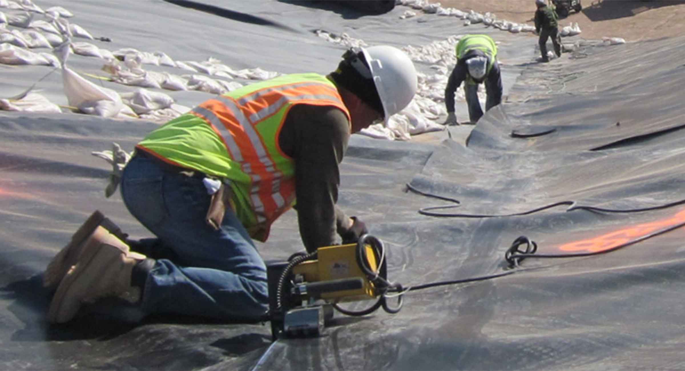 Workers installing industrial liner system
